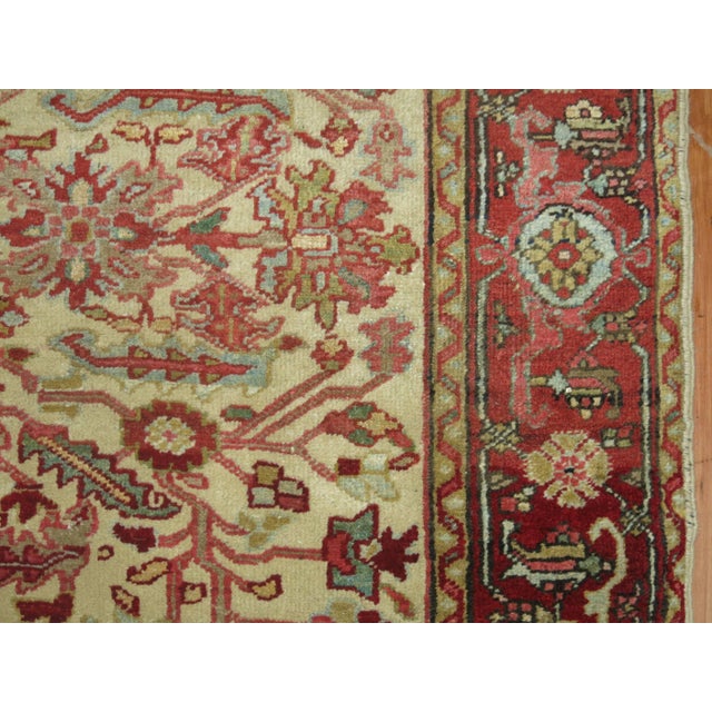 Rare size Persian Heriz carpet with an ivory ground and red border.