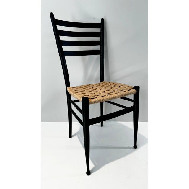 Set of Six Gio Ponti Style Wood Ladder Back Dining Chairs. Painted black, recently refinished, newly woven seats with...