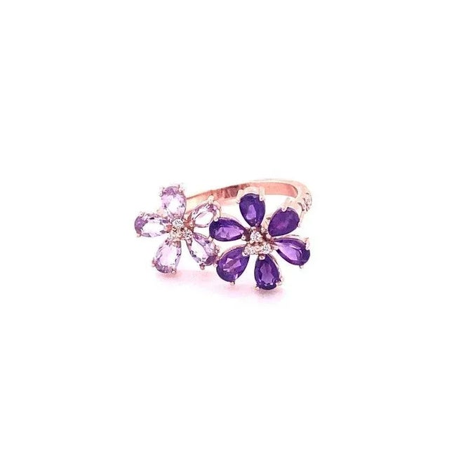 This ring has 5 Pink Amethysts and 6 African Purple Amethysts that weigh a total of 2.03 Carats and is embellished with 17...