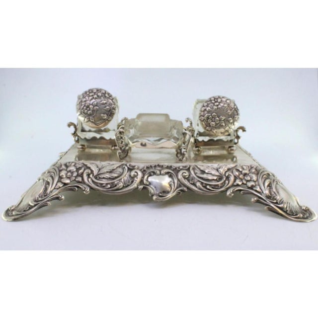 Inkwell in relief silver with floral motifs, two glass containers with reliefs on the lids and pen holders and glass...