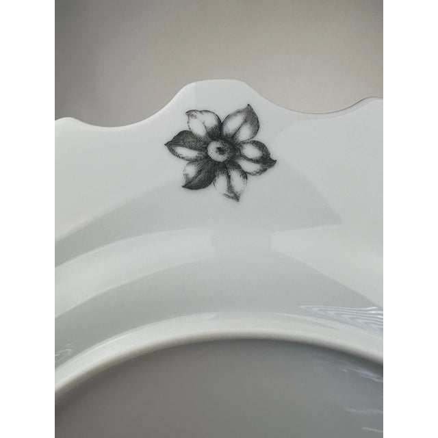 Striking Vista Alegre Herbariae dinner plates, designed by Christian Lacroix, featuring bold botanical imagery with rich...