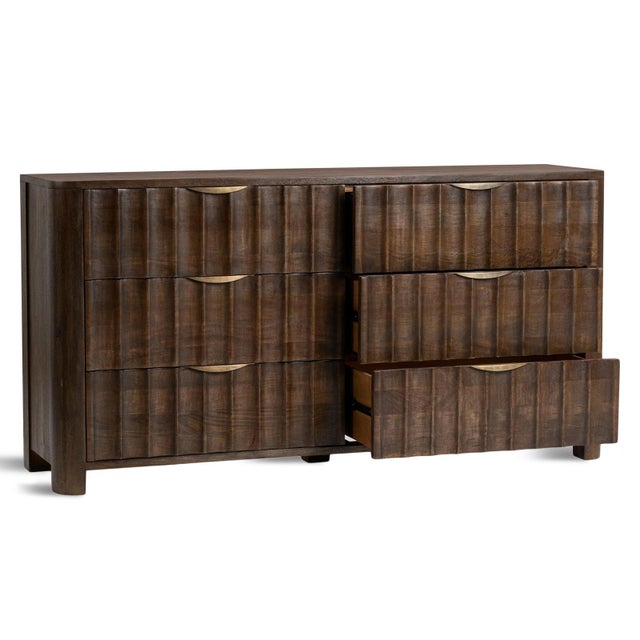 Six-drawer hand crafted solid mango wood dresser showcasing a sculptural fluted facade that brings depth, rhythm, and...