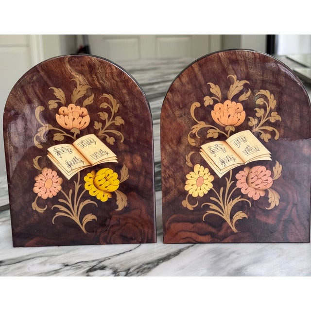 In the characteristic style of Italian inlay art, here is a pair of bookends featuring a floral and music book motif....