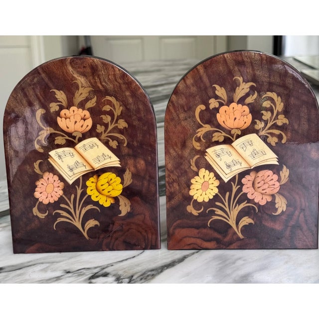 In the characteristic style of Italian inlay art, here is a pair of bookends featuring a floral and music book motif....
