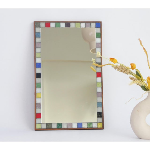 A colourful mid century rectangular mosaic mirror. The beautiful mirror has a nice colourful frame with ceramic tiles and...