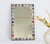 A colourful mid century rectangular mosaic mirror. The beautiful mirror has a nice colourful frame with ceramic tiles and...