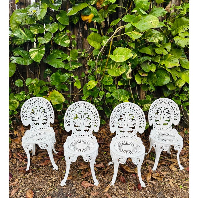 Beautiful vintage set of garden chairs white,with foliage design to the back, weathered patina. Classic style.
