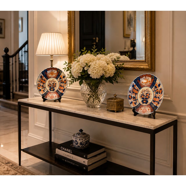 A beautiful pair of Japanese Imari porcelain plates dating from the early 20th century. These decorative pieces display...