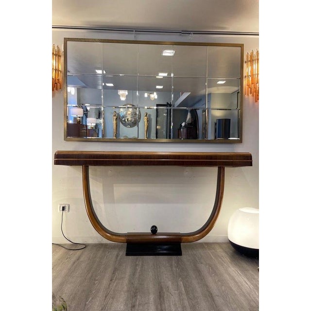 Art Deco console crafted in walnut and maple, dating to the 1940s. The flowing shape of the bent wood, enhanced by the...