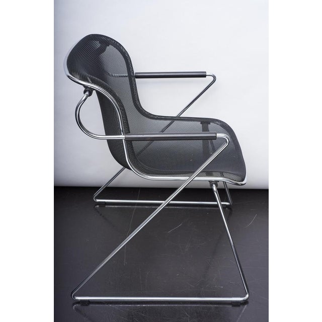 Penelope chair designed in 1982 by Charles Pollock for Anonima Castelli. Steel-wire sled base supports a seat permeable to...