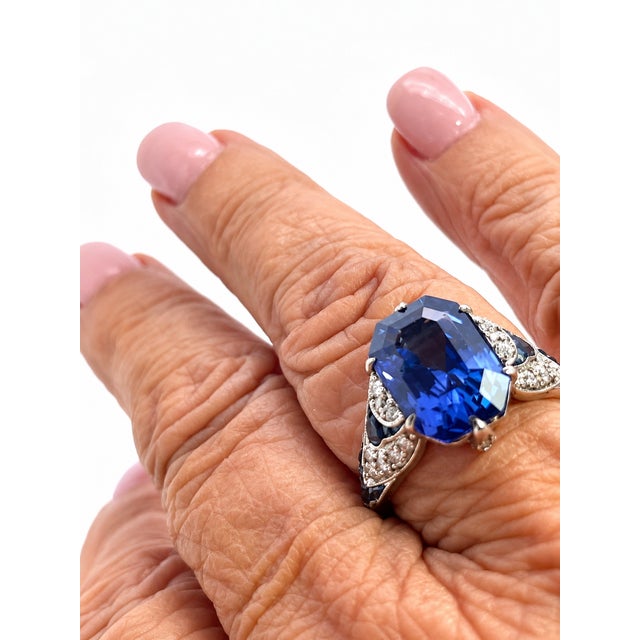 This striking Art Deco ring centers on a magnificent emerald-cut blue sapphire of 5.76 Carats NO HEAT with certificate,...