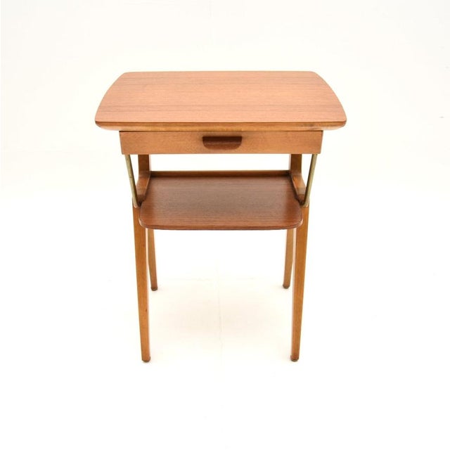 A stylish and useful vintage Swedish teak and brass bedside / side table. This was recently imported from Sweden, it dates...