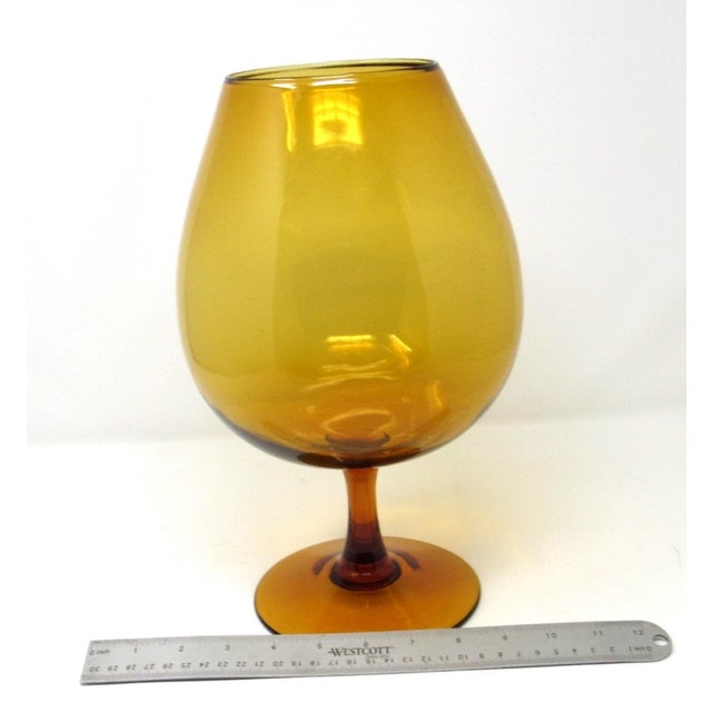 A vintage 1960s Italian Empoli hand-blown amber glass brandy snifter. This snifter is exceptionally large at 12 inches in...