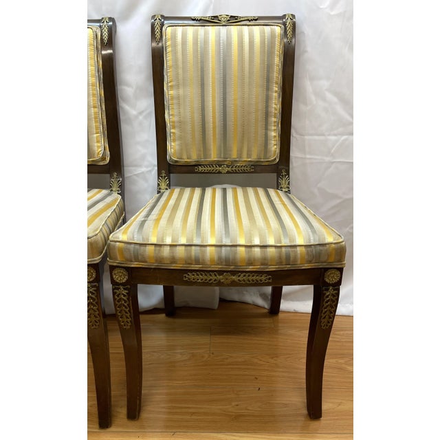 Pair of Napoleonic – style striped side chairs with gilded ormolu mounts