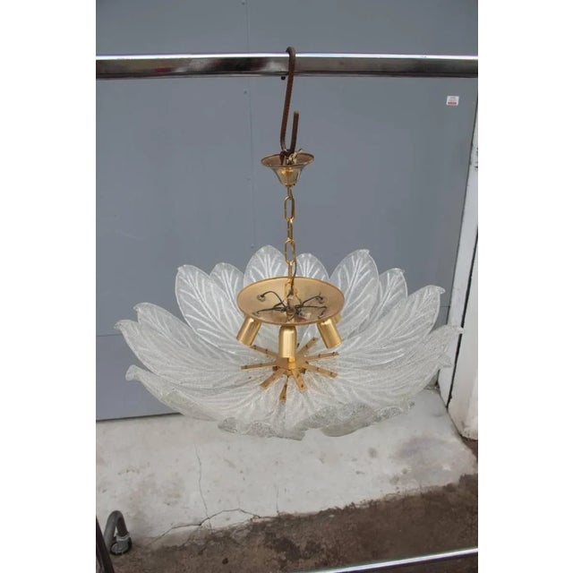 This Italian Murano glass chandelier dates from the 1970s. Up to 250V (Europe/UK Standard).The wiring of this item may be...