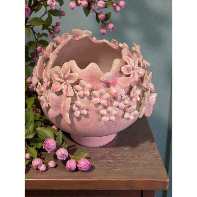 This vintage Italian glazed pottery vase features a beautiful pink floral design with a butterfly motif, adding a touch of...
