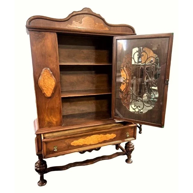 Antique Spanish Revival china cabinet matches a refectory table, upholstered dining chairs, and large buffet also for sale...