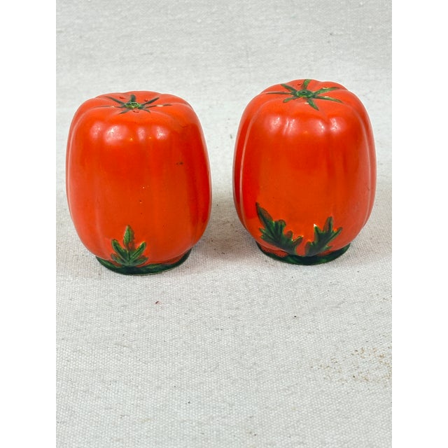 Vintage tomato shaped salt and pepper shakers produced in occupied Japan during 1947-1952 and identified as Maruhon ware....