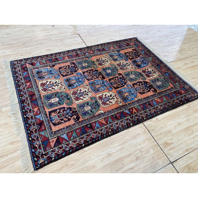 This vintage rug is hand-knotted in wool, woven in the Serab Persian design tradition. Measuring 5'1" x 7'2" (156 x 218...