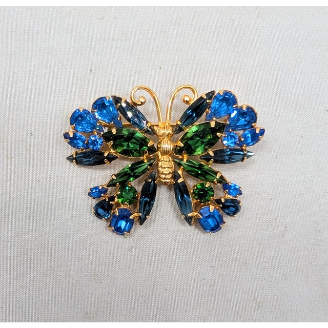 1950s goldtone prong set pear shaped, marquise and round faux-sapphires with marquise and round faux-emeralds butterfly...