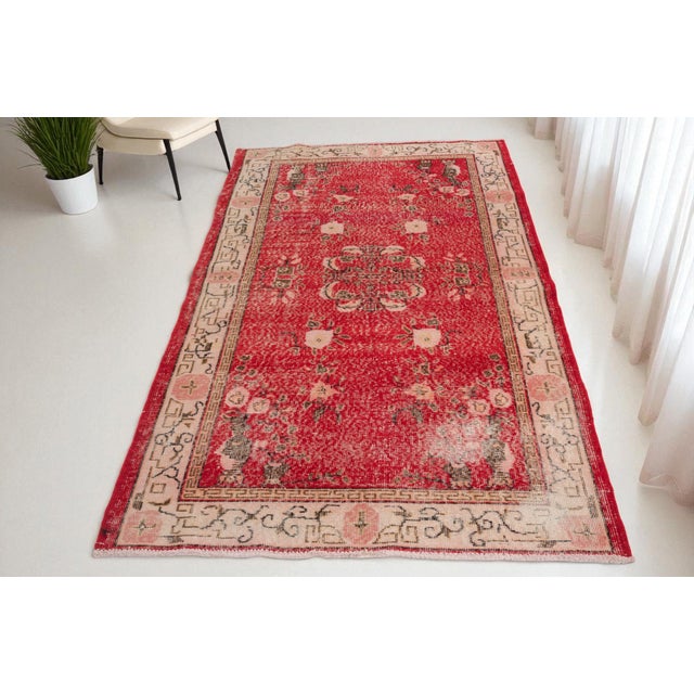 This is a vintage Turkish Oushak rug from the Mid 20th Century. The piece was hand-knotted.
