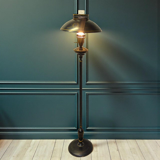Vintage turn-of -the-century fine reproduction 1970s French Empire style black metal toleware floor lamp. It features...