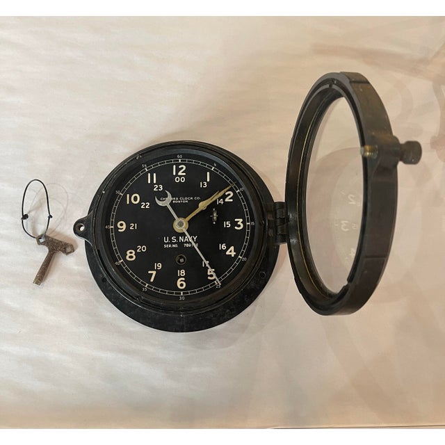 An authentic World War II-era U.S. Navy deck clock manufactured by the renowned Chelsea Clock Company of Boston,...