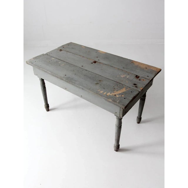 This is a country primitive antique wood table. The rustic farmhouse table features turned legs, classic soft gray paint,...