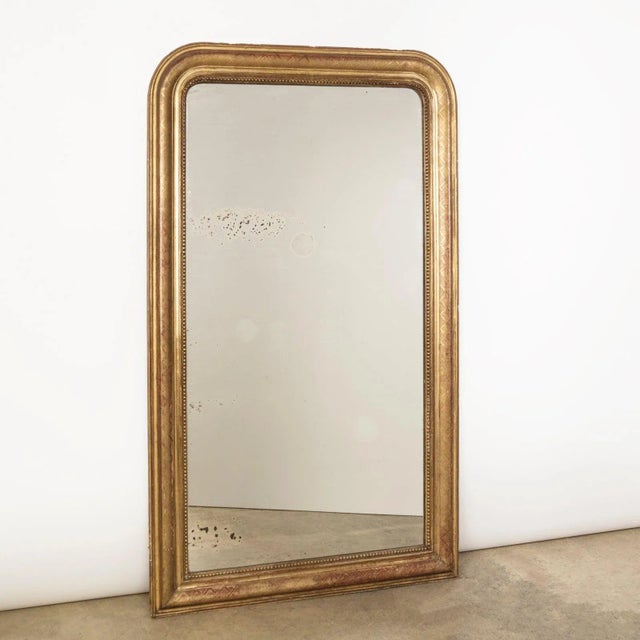 Antique French 19th Century Louis Philippe style gold gilt mirror etched with an x-pattern and its inner rim edged with a...
