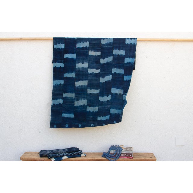 A masterwork of Malian textile heritage featuring deep indigo saturation and symbolic geometric motifs. Originating from...