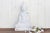 Truly of piece of art, this beautiful hand-carved statue of a sitting Buddha in pure white marble has finely carved facial...