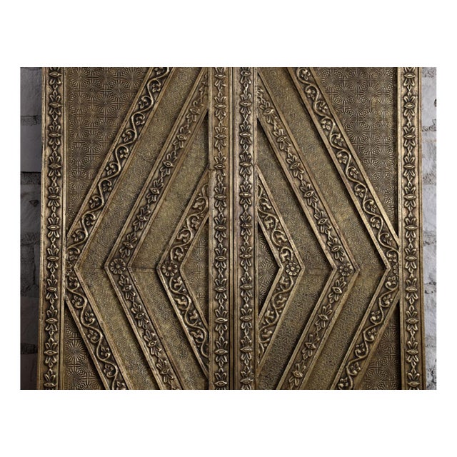 Make a bold architectural statement with this vintage hand-carved sliding barn door, accented with richly aged brass...