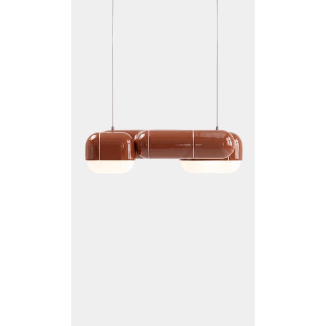 A pendant that changes with the day. In daylight its printed shell reads crisp and architectural, all shadow and ridge;...