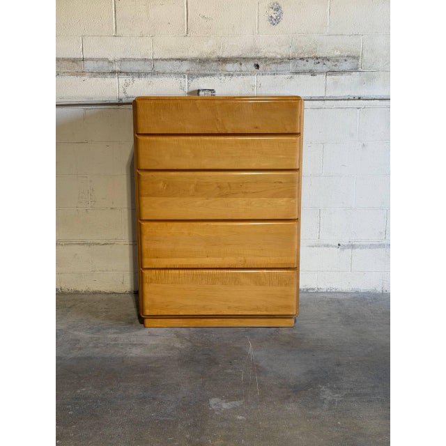 This vintage tallboy chest of drawers features a clean-lined geometric silhouette and integrated recessed finger pulls for...
