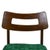 A set of four mid century dining chairs with sculptural open backs and seats newly upholstered in emerald green. The warm...