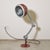 A lamp with a decidedly industrial vintage charm, straight from a mid-twentieth-century machine shop or workshop. It's a...