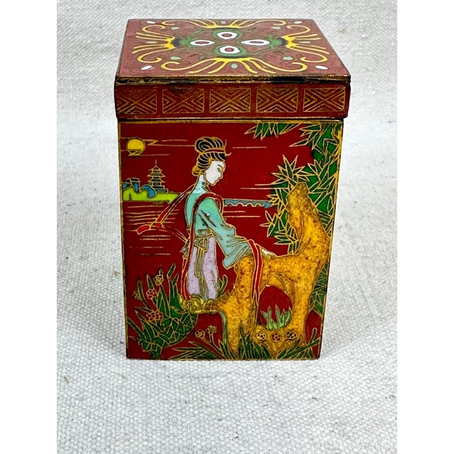 Vintage Chinese cloisonné tea caddy box with detailed garden scenes featuring a traditional woman’s figure. This is a pre-...