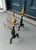 Elegant pair of Federal style antique andirons featuring classic brass urn finials atop turned black iron shafts, raised...