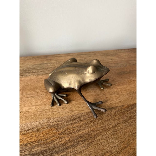 A whimsical large brass frog figure poised on sweet, webbed feet. Maybe the prince you've been looking for.