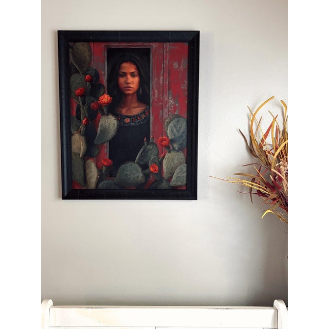 Resilience in Bloom features a striking portrait of a woman framed by vibrant cacti and blooming flowers, symbolizing...