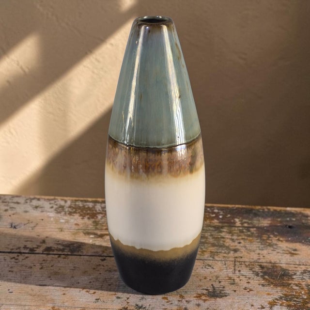 This Mid-Century-Modern Glazed Pottery Multi Colored Tube Vase is a stylish and unique piece of decorative pottery. Made...