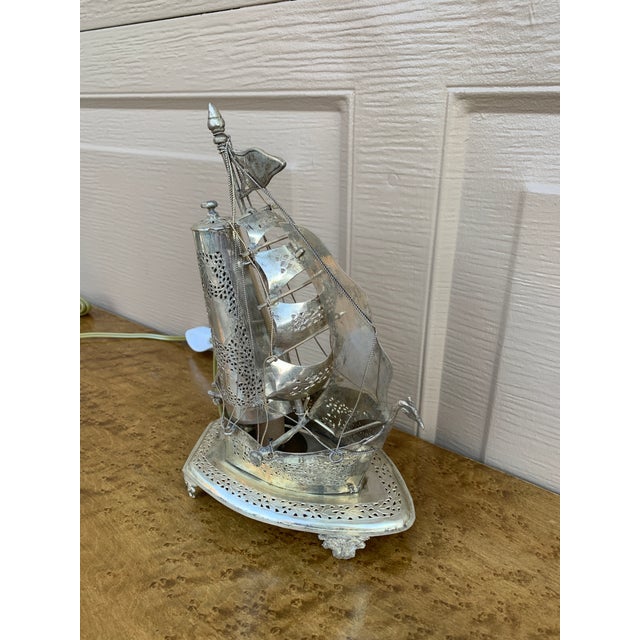 An unusual and beautifully detailed mid-20th century German silver sailing ship nightlight that effortlessly bridges...
