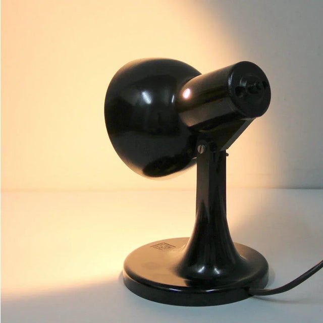 - Made entirely in Bakelite - Has a switch on the back of the screen and an E27 cap - The screen moves - The maximum...