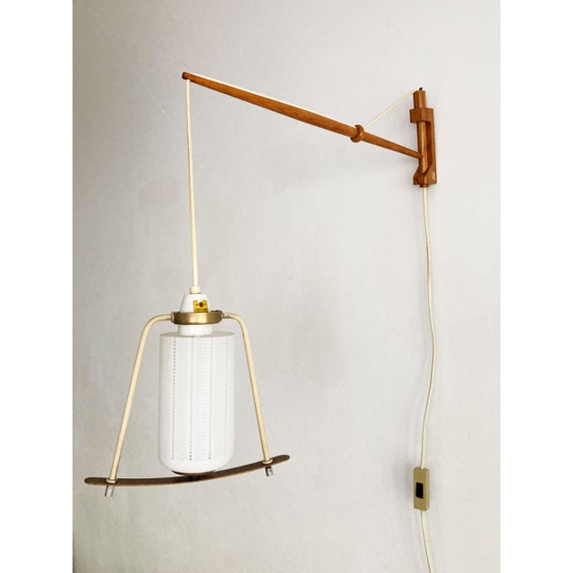 The design echoes the refined minimalism of Danish modern lighting. Its a reminiscent of works by A. Bang Jensen and Kjeld...