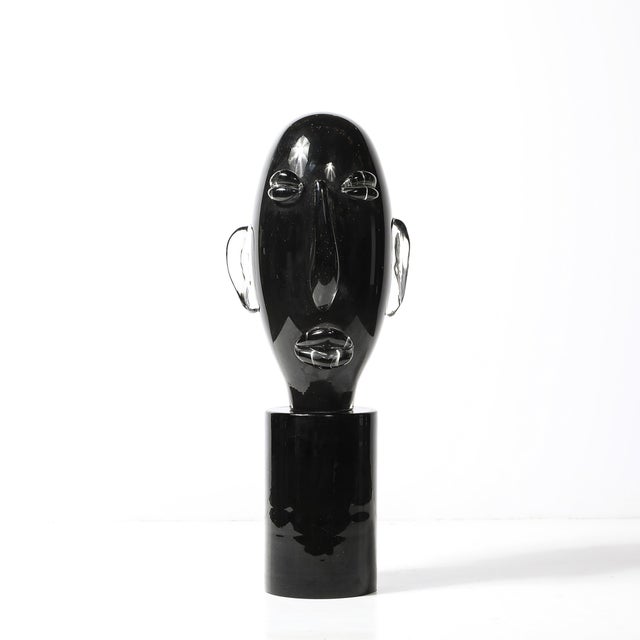This Mid-Century Modernist hand-blown Murano black glass head sculpture, signed by Sergio Rossi and crafted in Italy circa...