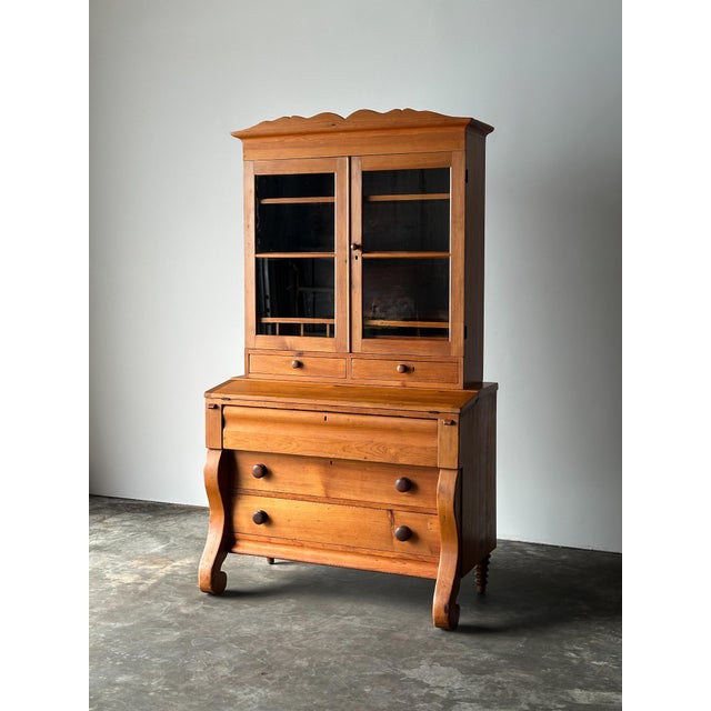 This 19th century antique works in three parts — bookcase, writing desk, and chest of drawers — built to handle all three...