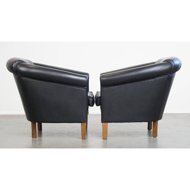 Beautiful set of 2 black English style cowhide club chairs with a timeless design. This beautiful set of cowhide leather...