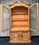 Beautiful Heritage Furniture display cabinet with a warm honey-toned wood finish and elegant European country styling. Its...