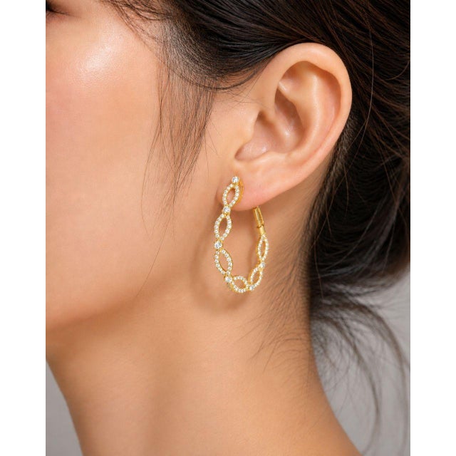 Elegant 14K yellow gold diamond hoop earrings featuring numerous brilliant round diamonds totaling 1.7 carats. Estate pair...