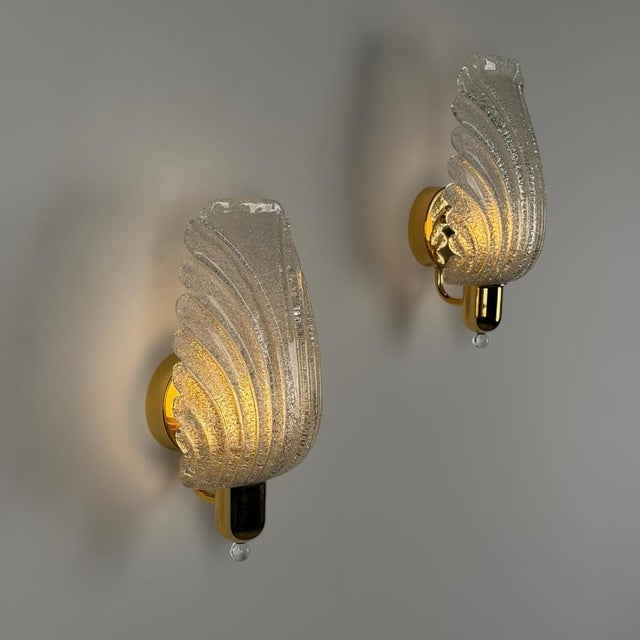 A beautiful and important pair of large Murano glass wall sconces produced by Barovier & Toso in the 1980s, designed with...